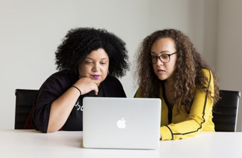 Two women looking at a laptop
