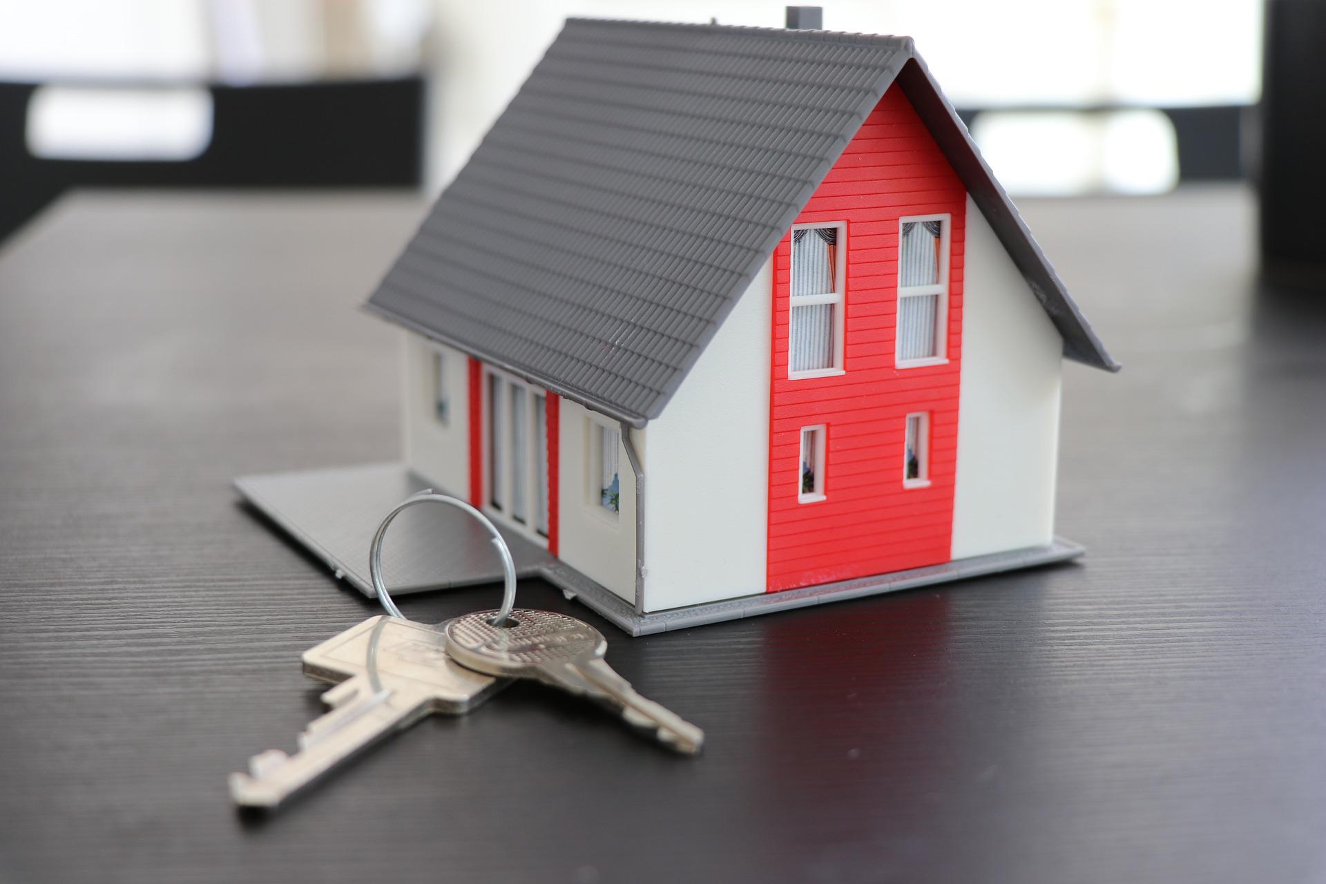 tiny toy house and keys on a table